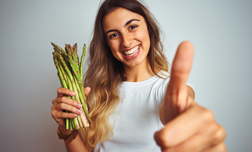 Happy woman with Asparagus